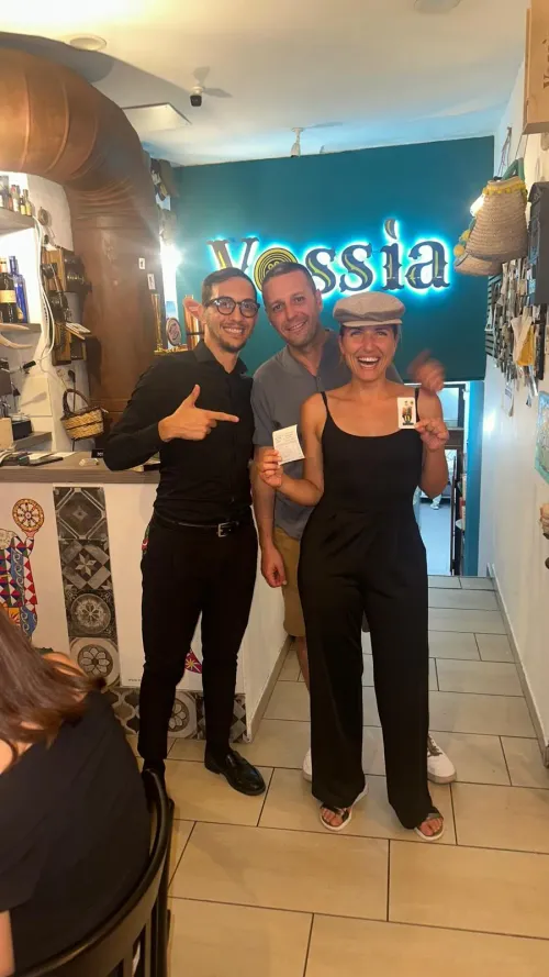 Clienti di Vossìa davanti all'insegna al neon del locale