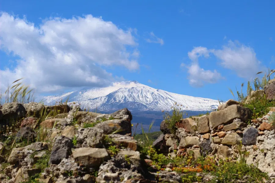 Snow-capped Mount Etna seen from the countryside